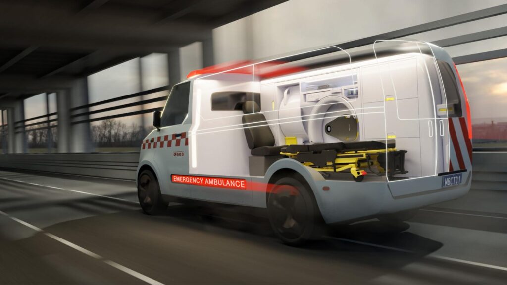 Interior of a standard road ambulance featuring a compact Micro-X portable Head CT scanner positioned at the head of a patient stretcher.
