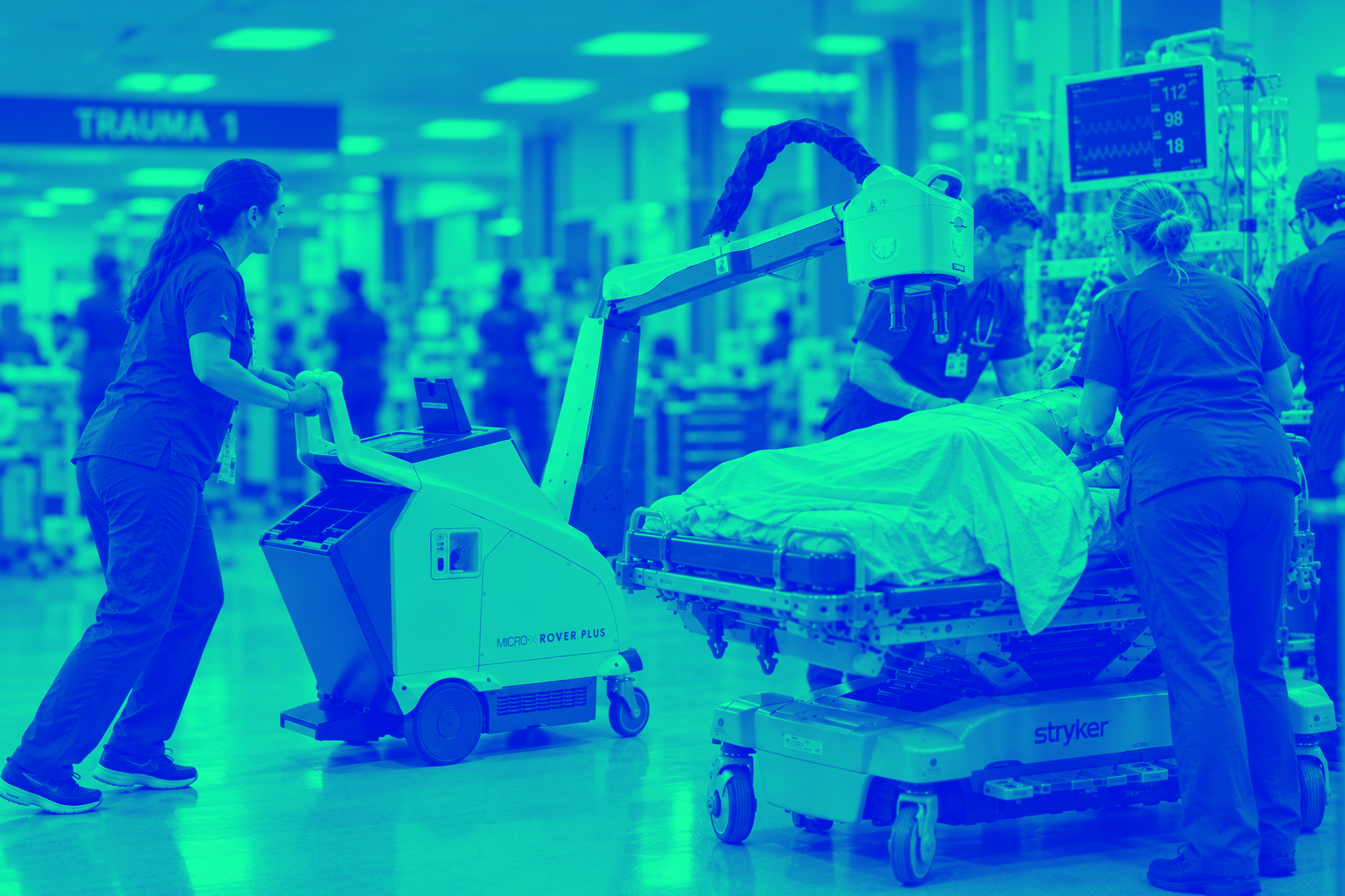 Micro-X Rover Plus portable X-ray positioned over a patient in a busy ER trauma bay